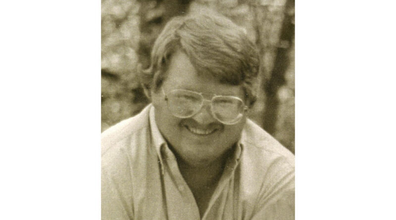A portrait of a man wearing glasses