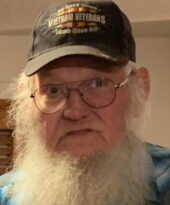 An old man with a long white beard wearing a cap