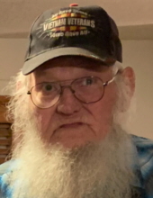 An old man with a long white beard wearing a cap