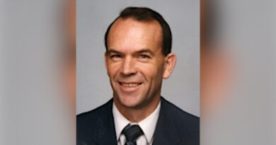 A portrait of a man in a corporate top