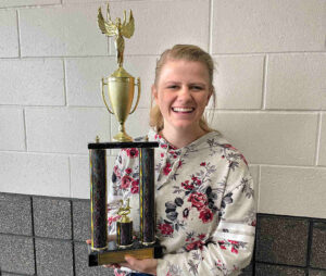 A girl holding a trophy