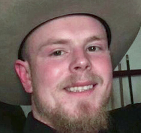 A bearded man wearing a cowboy hat