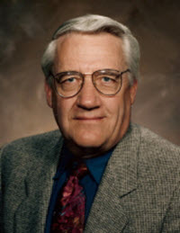 A portrait of an elderly man with a studio background
