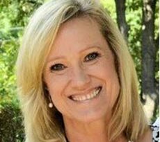 A headshot portrait of a blonde woman