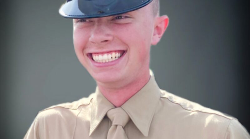 A cadet smiling brightly