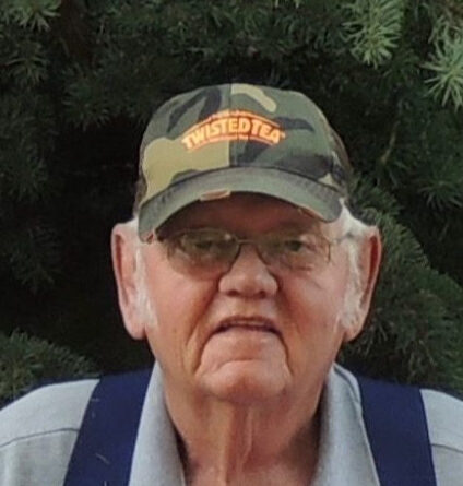 An elderly man wearing a cap