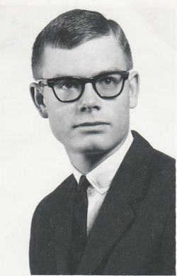 A black and white image of a man wearing glasses